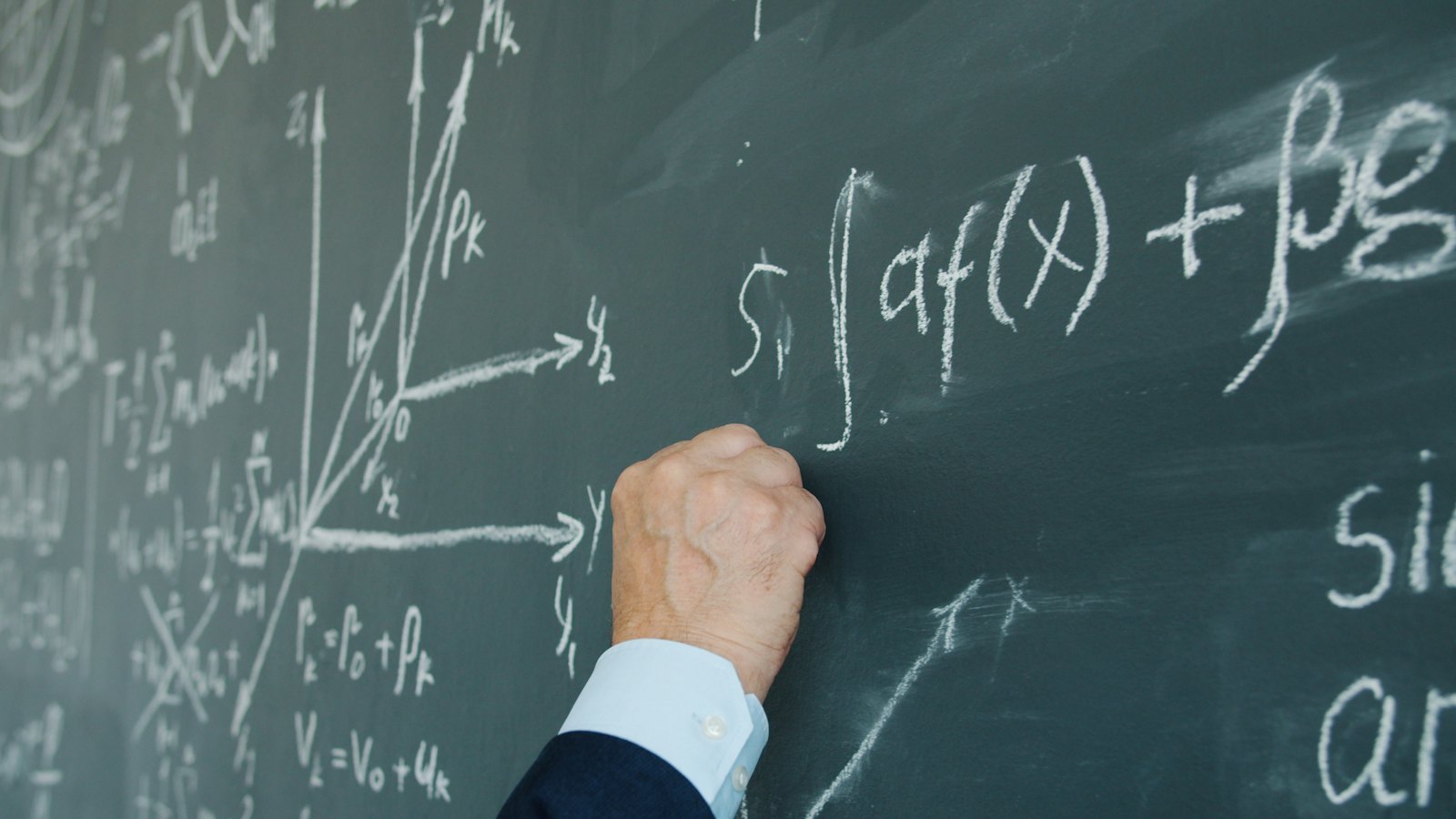 Ruka ispisuje matematičke formule na tabli